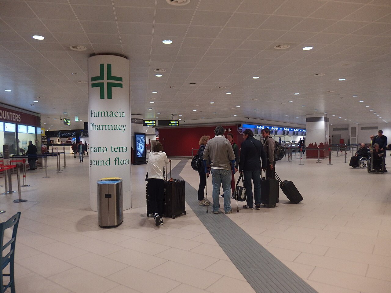 Travelers with luggage at Bologna's airport